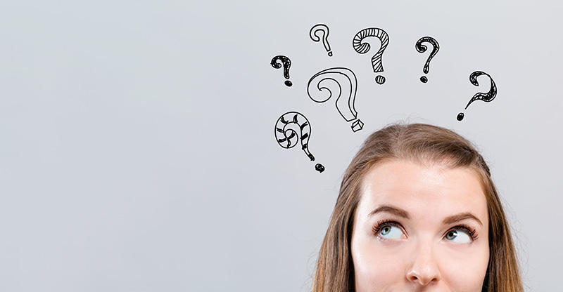 Hand drawn question marks with woman looking upwards on a gray background.